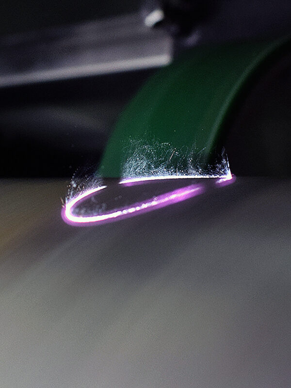 Circular laser up close while cleaning an anilox roll.